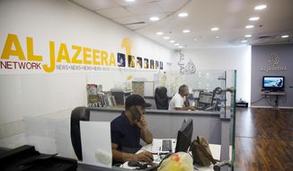 Employees sit in Al-Jazeera news network offices in Jerusalem, Tuesday August 8, 2017. Al-Jazeera, the Qatar-based news network that broadcasts internationally in English and Arabic, has once again been thrust into the center of the story, with the network&#39;s coverage back in the spotlight after Israel&#39;s moves to block it. (AP Photo/Mahmoud Illean)