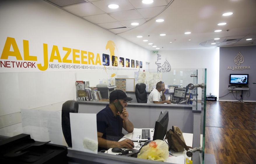 Employees sit in Al-Jazeera news network offices in Jerusalem, Tuesday August 8, 2017. Al-Jazeera, the Qatar-based news network that broadcasts internationally in English and Arabic, has once again been thrust into the center of the story, with the network's coverage back in the spotlight after Israel's moves to block it. (AP Photo/Mahmoud Illean)