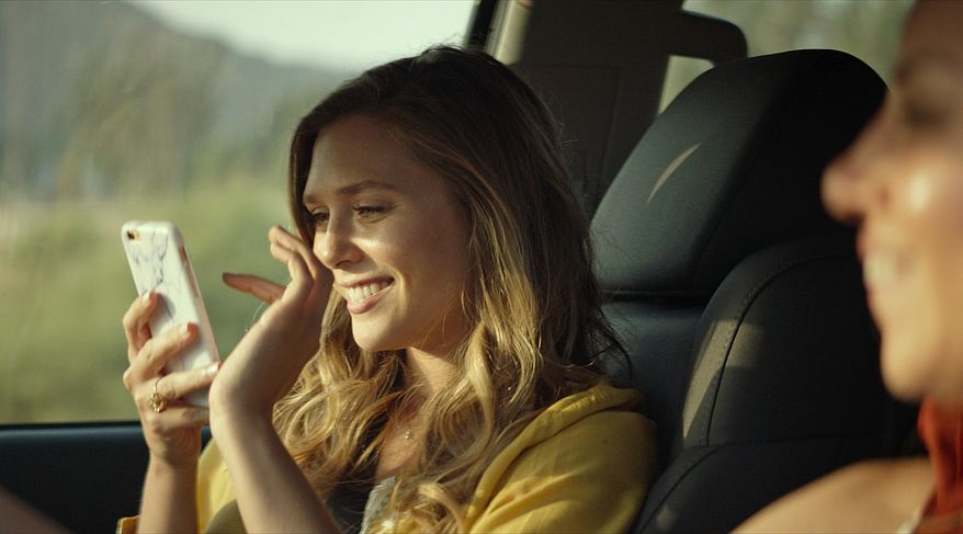 This image released by Neon shows Elizabeth Olsen in a scene from "Ingrid Goes West." (Neon via AP)