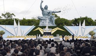 Doves fly over the Statue of Peace at Nagasaki Peace Park in Nagasaki, southern Japan during a ceremony to mark the 72nd anniversary of the world&#39;s second atomic bomb attack over the city, Wednesday, Aug. 9, 2017. (Nozomu Endo/Kyodo News via AP)