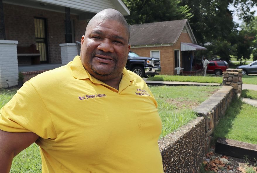 The Rev. Benny Johnson, of the Arkansas Stop the Violence movement, prepares for a news conference in Little Rock, Ark., on Tuesday, Aug. 8, 2017, near the home of a man killed early Sunday in a home-invasion robbery. Arkansas' capital city has seen 39 homicides so far in 2017. (AP Photo/Kelly P. Kissel)