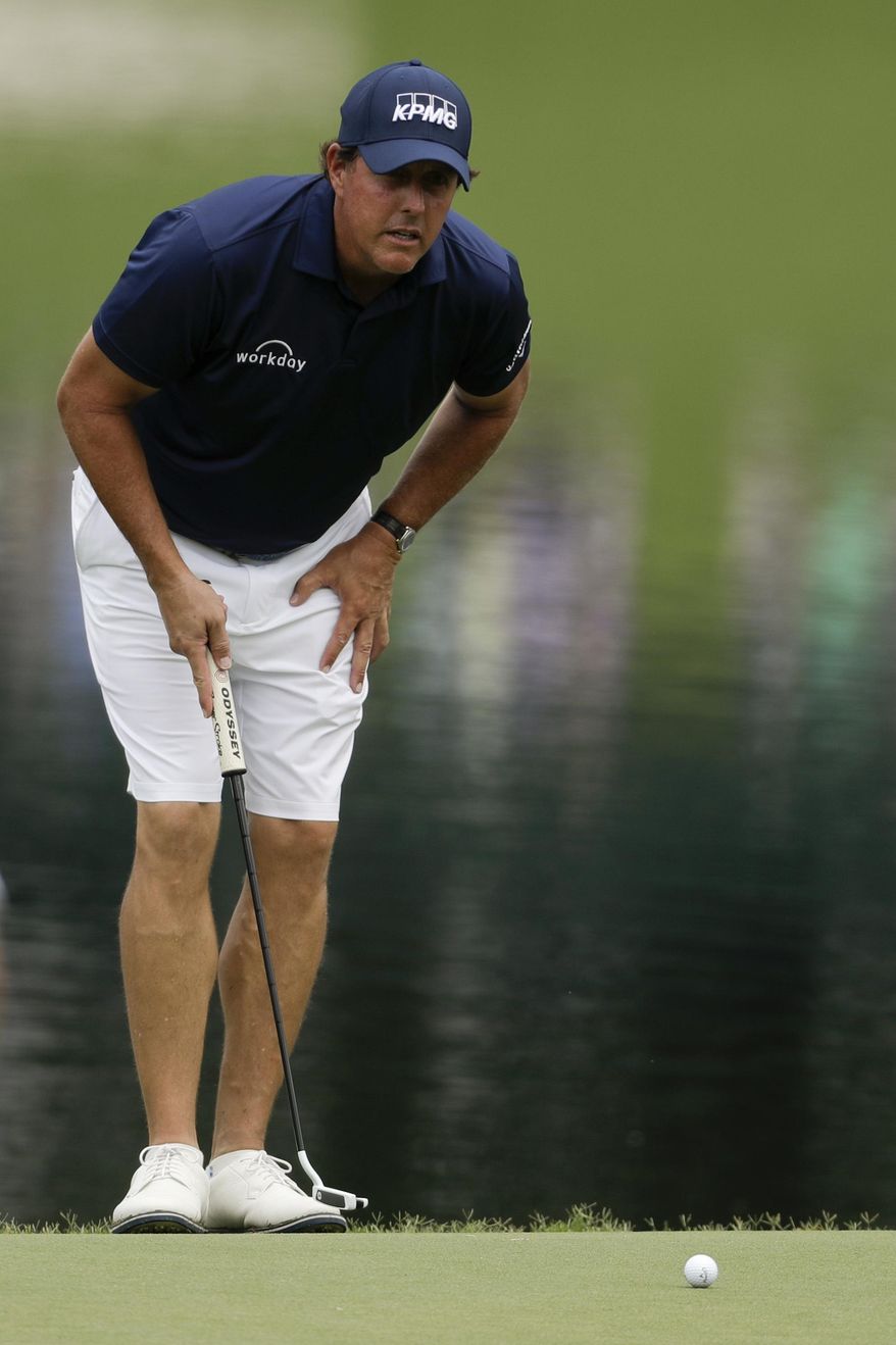 Phil Mickelson lines up a putt on the 17th hole during a practice round at the PGA Championship golf tournament at the Quail Hollow Club Tuesday, Aug. 8, 2017, in Charlotte, N.C. (AP Photo/Chris Carlson)