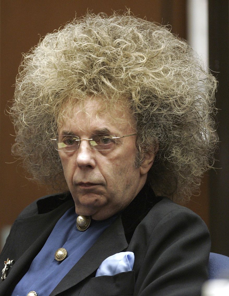 FILE - In this May 23, 2005 file photo music producer Phil Spector appears during his trial at the Los Angeles Superior Court in Los Angeles. A June 14, 2017 mugshot provided by the California Department of Corrections and Rehabilitation shows Spector completely free of the huge hair that was so striking during his murder trial. The 76-year-old music producer is smiling broadly and wearing hearing aids on both ears. He was convicted in 2009 of killing actress Lana Clarkson, and is serving a sentence of 19 years to life. (AP Photo/Damian Dovarganes, File)