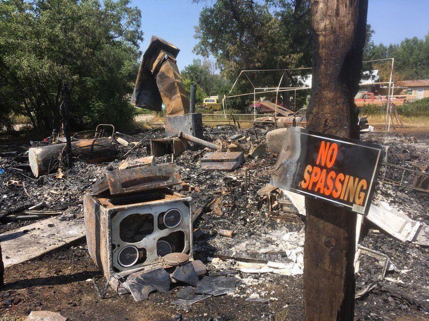 A house on Montana's Crow Indian reservation where three people were shot and killed last week has burned to the ground, officials said Tuesday, Aug. 8, 2017.The fire destroyed the one-story house in the town of Lodge Grass where tribal officials have said a dispute linked to methamphetamine last Friday prompted the killing of three people who entered the home. (Larry Mayer /The Billings Gazette via AP)