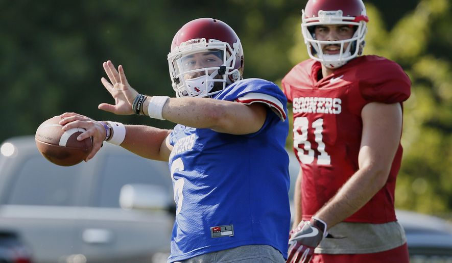 FILE In this Aug. 3, 2017, file photo, Oklahoma quarterback Baker Mayfield, left, throws in front of tight end Mark Andrews (81) during an NCAA college football practice in Norman, Okla. Oklahoma, with Heisman Trophy finalist quarterback Mayfield back for his senior season, will be going for its third consecutive Big 12 title, and 11th overall. (AP Photo/Sue Ogrocki, File)