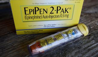 This Oct. 10, 2013, file photo, shows an EpiPen epinephrine auto-injector, a Mylan product, in Hendersonville, Texas. Mylan reports earnings Wednesday, Aug. 9, 2017. (AP Photo/Mark Zaleski, File)