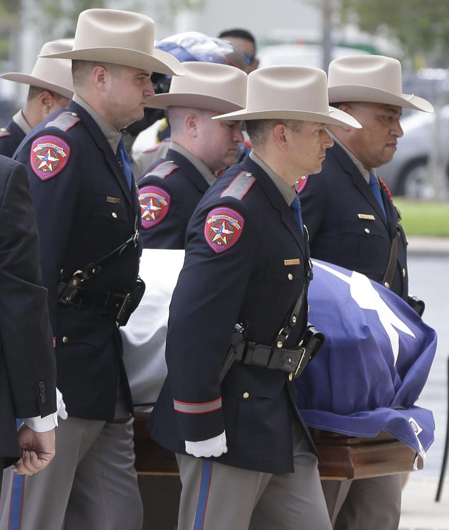 Texas Dept. Public Safety Honor Guard members escort the casket into the memorial service for former Texas Governor Mark White at Second Baptist Church, Wednesday, Aug. 9, 2017 in Houston. White, who battled kidney cancer, died Saturday at age 77. (Melissa Phillip/Houston Chronicle via AP)