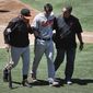 Baltimore Orioles&#39; Joey Rickard, center, leaves the field with manager Buck Showalter, left, and a trainer after he was hit by a pitch during the sixth inning of a baseball game against the Los Angeles Angels, Wednesday, Aug. 9, 2017, in Anaheim, Calif. (AP Photo/Jae C. Hong)