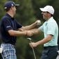 Rory McIlroy of Northern Ireland, right, and Justin Thomas share a laugh ninth hole during a practice round at the PGA Championship golf tournament at the Quail Hollow Club Wednesday, Aug. 9, 2017, in Charlotte, N.C. (AP Photo/Chris Carlson)