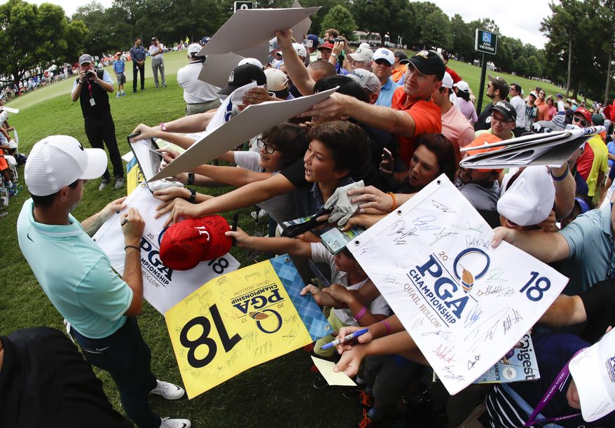 Rory McIlroy of Northern Ireland, signs autographs after a practice round at the PGA Championship golf tournament at the Quail Hollow Club Wednesday, Aug. 9, 2017, in Charlotte, N.C. (AP Photo/Chris Carlson)