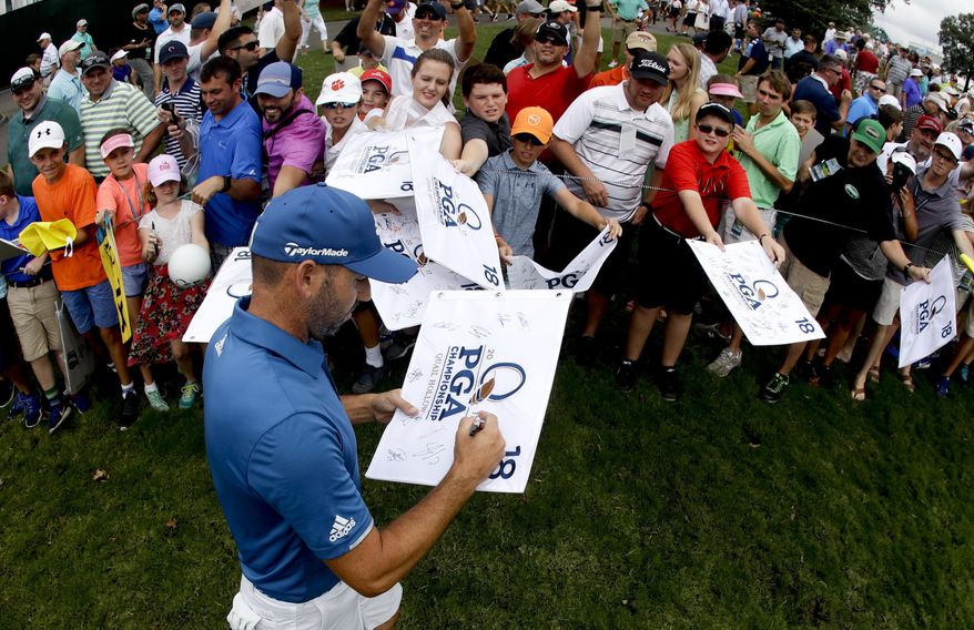 Sergio Garcia, of Spain, signs autographs after a practice round at the PGA Championship golf tournament at the Quail Hollow Club Wednesday, Aug. 9, 2017, in Charlotte, N.C. (AP Photo/Chris Carlson)