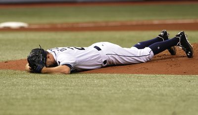 Tampa Bay Rays starter Jake Odorizzi lays prone on the mound after he was hit in the right leg by a line drive from Boston Red Sox&#39;s Eduardo Nunez during the fifth inning of a baseball game Wednesday, Aug. 9, 2017, in St. Petersburg, Fla. (AP Photo/Steve Nesius)