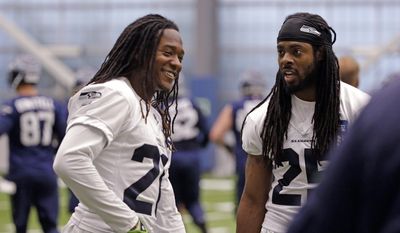FILE - In this June 15, 2017, file photo, Seattle Seahawks&#39; Shaquill Griffin, and Richard Sherman talk between drills at NFL football practice in Renton, Wash. Even though he&#39;s now a professional, Griffin is still in school. And in this case, Sherman is the teacher. It&#39;s part of the Seattle Seahawks examination of Griffin and how soon the rookie could step in as the cornerback opposite Sherman. (AP Photo/Elaine Thompson, File)