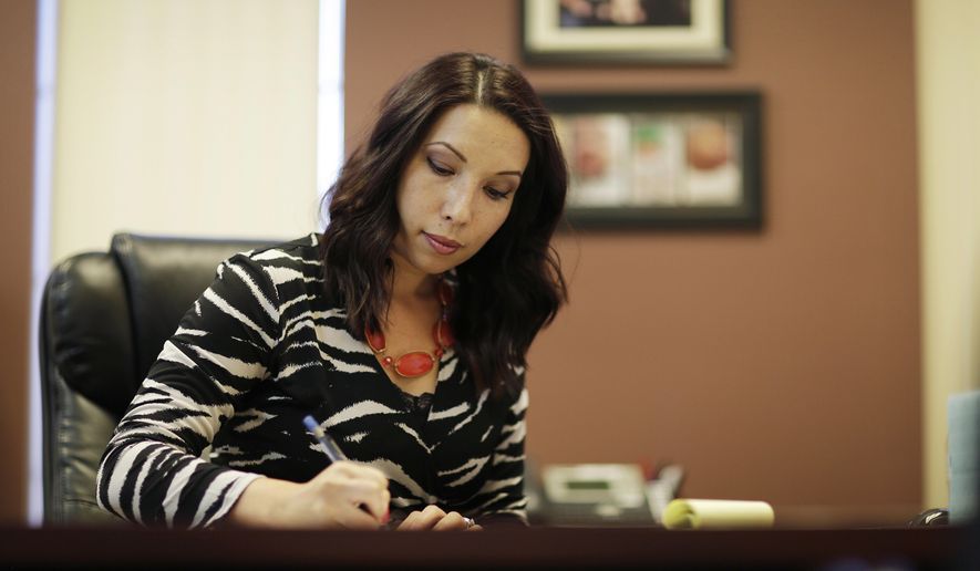 In this Aug. 2, 2017, photo, Jessica Sayles, a certified public accountant, works in her office in Las Vegas. Sayles is thinking about who might take over for her when she retires from the accounting firm where she is managing partner, even though that's still more than 20 years away. (AP Photo/John Locher)