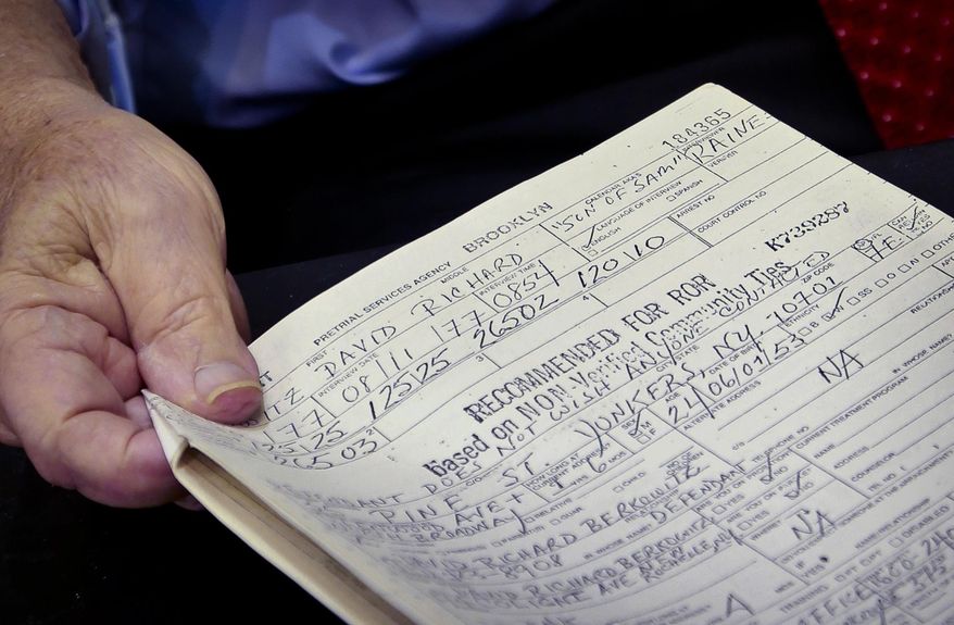 Queens District Attorney Richard A. Brown, who in 1977 was the supervising Brooklyn judge in the arraignment of the "Son of Sam" serial killer David Berkowitz, shows a court document recommending his release, during an interview in his office, Wednesday Aug. 9, 2017, in New York. Forty years ago city officials actually recommended Berkowitz be free on bail, but Brown disagreed and held him for killing six and wounding seven,primarily young women sitting in cars. (AP Photo/Bebeto Matthews)