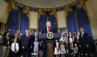 FILE - In this July 24, 2017, file photo, President Donald Trump, accompanied by Vice President Mike Pence, Health and Human Services Secretary Tom Price, and others, speaks about healthcare, in the Blue Room of the White House in Washington. A study by a nonpartisan group says the Trump administration’s own actions are triggering double-digit premium increases on individual health insurance policies purchased by millions of consumers. (AP Photo/Alex Brandon, File)