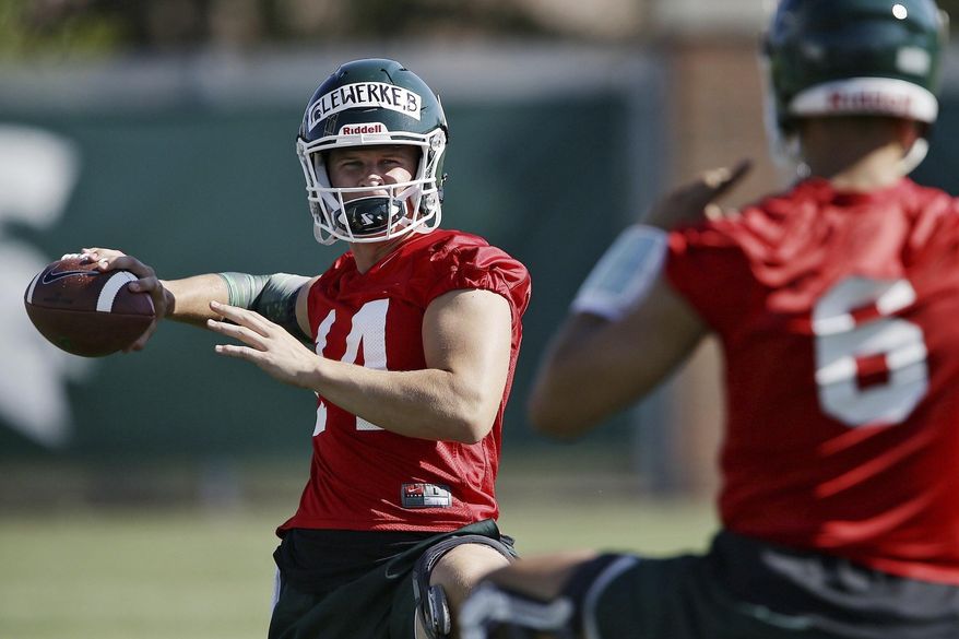 FILE- In a July 31, 2017, file photo, Michigan State quarterback Brian Lewerke (14) warms up during NCAA college football practice in East Lansing, Mich. Lewerke is the favorite to take over as the starting quarterback. He appeared in four games in 2016 before a season-ending broken leg. (Mike Mulholland/The Ann Arbor News via AP, File)