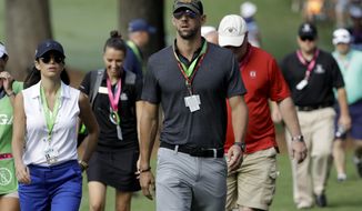 Swimmer, Michael Phelps walks the back ninth during the first round of the PGA Championship golf tournament at the Quail Hollow Club Thursday, Aug. 10, 2017, in Charlotte, N.C. (AP Photo/Chris O&#39;Meara)