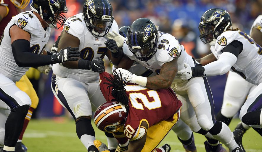 Washington Redskins running back Rob Kelley (20) is tackeld by a group of Baltimore Ravens defenders in the first half of a preseason NFL football game, Thursday, Aug. 10, 2017, in Baltimore. (AP Photo/Nick Wass)