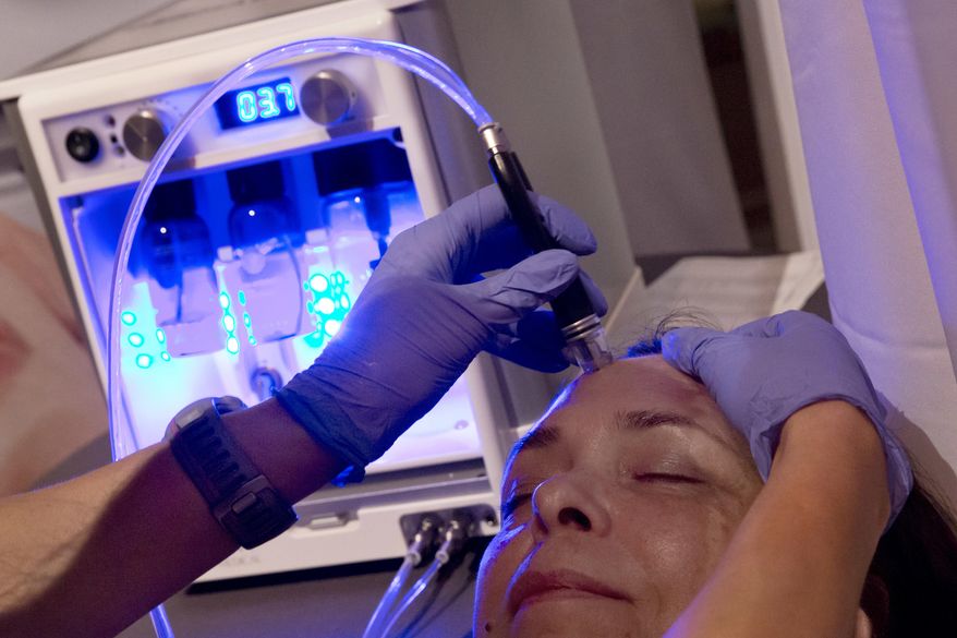 In this Aug. 8, 2017 photo, dermalinfusion, by Envy Medical of Long Beach, Calif., an advanced skin resurfacing treatment, is demonstrated at the annual International Spa Association event in New York. Wellness rather than beauty was the message this week as the spa industry gathered in New York for an annual event organized by the International Spa Association. While there were plenty of skin products and treatments on display, the bigger trend remains alleviating stress. (AP Photo/Richard Drew)