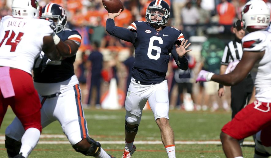 FILE - In this Oct. 29, 2016, file photo, Virginia quarterback Kurt Benkert (6) throws a pass during the team's NCAA college football game against Louisville in Charlottesville, Va. Benkert took nearly all the snaps in spring practice, and the only other player to take any, redshirt freshman De'Vante Cross, has also been working at wide receiver this fall. (AP Photo/Ryan M. Kelly, File)