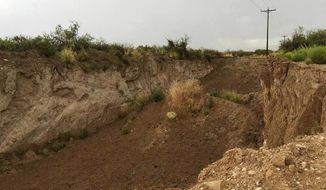 This image provided by New Mexico State Land Office shows the scene of the alleged dirt theft in Otero County, N.M., Friday, Aug. 11, 2017. The New Mexico State Land Office is going after a West Texas county after it was learned that loads of dirt, sand and gravel were disappearing from the parcel of state trust land along the border.(Robert Kasuboski/New Mexico State Land Office via AP)