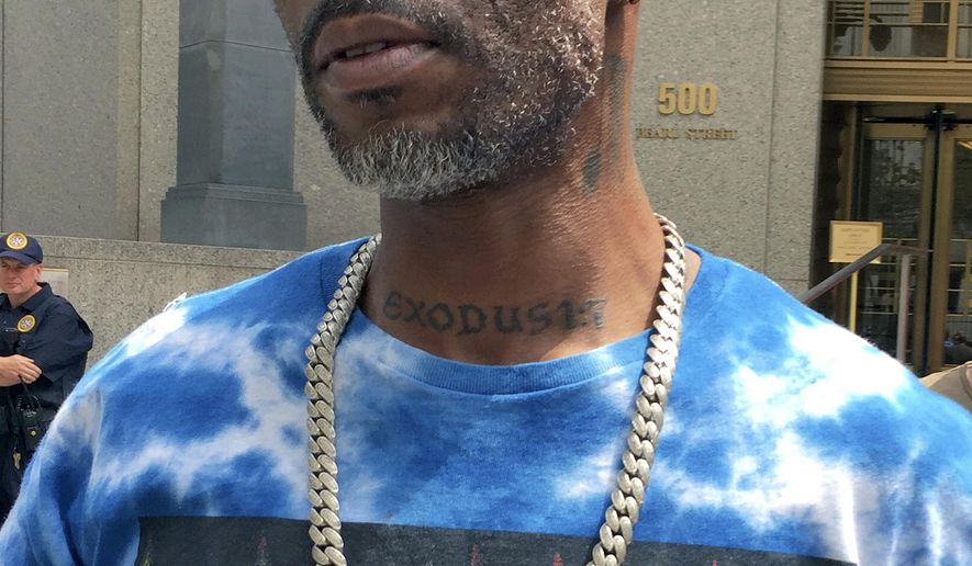Rapper DMX, left, whose given name is Earl Simmons, leaves federal court in New York, Friday, Aug. 11, 2017. DMX, who prosecutors say owes $1.7 million in taxes, was ordered confined to his suburban New York City home Friday by a judge who said he repeatedly violated bail conditions on the tax fraud charges. (AP Photo/Larry Neumeister)