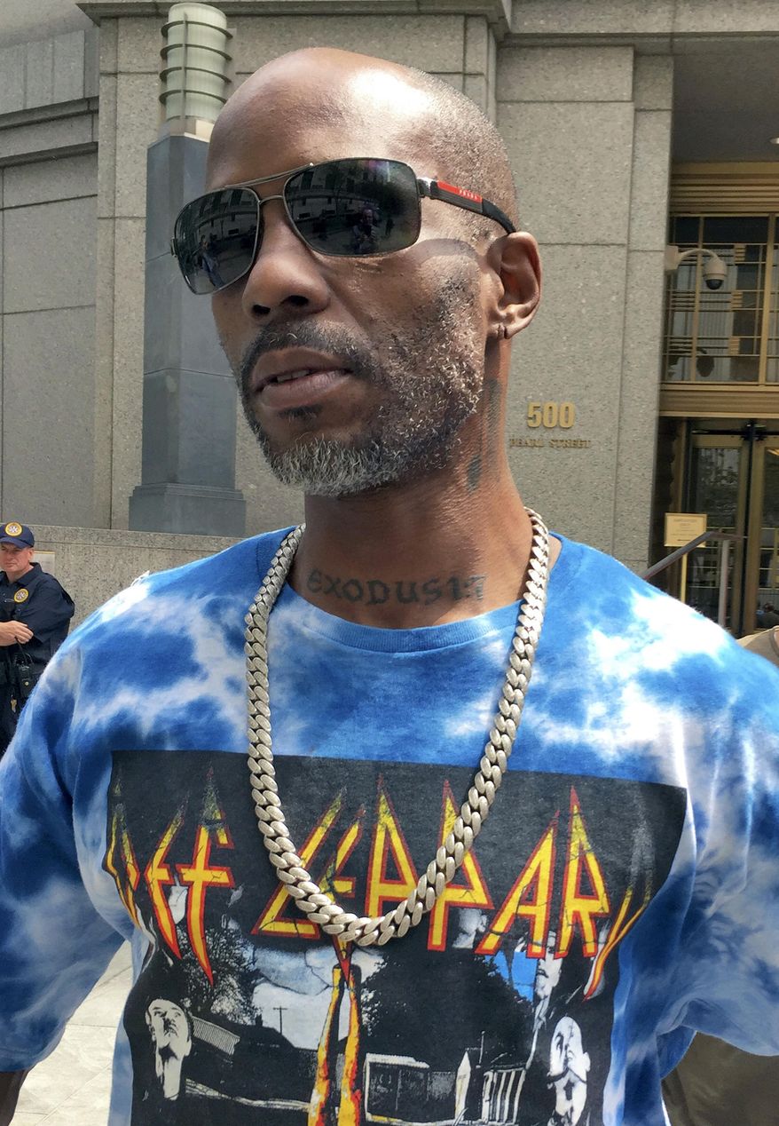 Rapper DMX, left, whose given name is Earl Simmons, leaves federal court in New York, Friday, Aug. 11, 2017. DMX, who prosecutors say owes $1.7 million in taxes, was ordered confined to his suburban New York City home Friday by a judge who said he repeatedly violated bail conditions on the tax fraud charges. (AP Photo/Larry Neumeister)