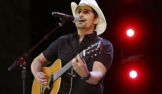 FILE - In this June 2, 2017 file photo, Country music recording artist Brad Paisley performs at the graduation for Barrington High School, at Willow Creek Community Church in South Barrington, Ill. Paisley says years of hosting the Country Music Awards and writing songs with humorous lyrics have - hopefully - prepared him to host his first comedy special, the “Brad Paisley Comedy Rodeo,” which will premiere on Netflix on Tuesday, Aug. 15. (Steve Lundy /Daily Herald via AP, File)