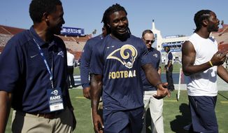 Newly acquired Los Angeles Rams wide receiver Sammy Watkins, center, walks with a team official before the Rams play the Dallas Cowboys in a preseason NFL football game Saturday, Aug. 12, 2017, in Los Angeles. Watkins was acquired from the Buffalo Bills. (AP Photo/Jae C. Hong)