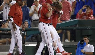 Washington Nationals&#39; Bryce Harper, second from right, is helped off the field after he was injured during the first inning of a baseball game against the San Francisco Giants, Saturday, Aug. 12, 2017, in Washington. (AP Photo/Nick Wass)
