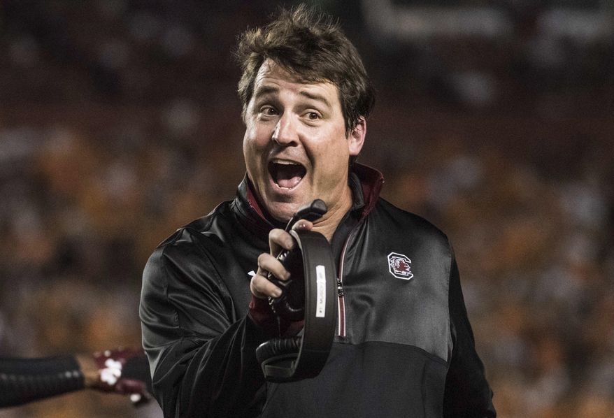 FILE - In this Oct. 29, 2016, file photo, South Carolina head coach Will Muschamp communicates with a referee during the first half of an NCAA college football game against Tennessee, in Columbia, S.C. South Carolina coach Will Muschamp boiled his team's problems last year to two things: Running successfully and stopping the run. (AP Photo/Sean Rayford, File)
