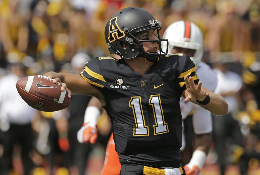 FILE - In this Sept. 17, 2016, file photo, Appalachian State's Taylor Lamb (11) looks to pass against Miami during the first half of an NCAA college football game, in Boone, N.C. Appalachian State, which shared the Sun Belt title a season ago, is now the league’s preseason favorite in 2017, according to a poll of coaches and selected media. (AP Photo/Chuck Burton, File)