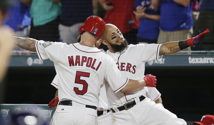 Texas Rangers&#x27; Mike Napoli (5) is congratulated by Rougned Odor after hitting a solo home run during the fourth inning of a baseball game against the Houston Astros on Saturday, Aug. 12, 2017, in Arlington, Texas. (AP Photo/Brandon Wade)