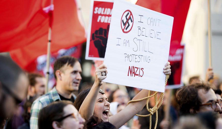 Larisa Roberts joins protesters in Oakland, Calif., during a counter protest to a rally by white nationalists in Charlottesville, Va., on Saturday, Aug. 12, 2017. (AP Photo/Noah Berger)