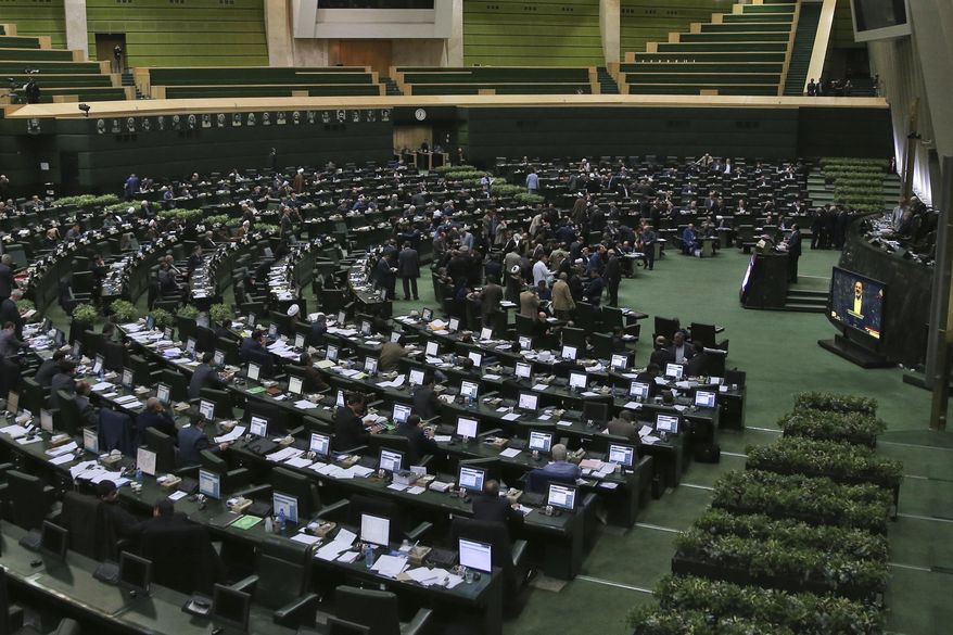 This photo taken on Sunday, Feb. 19, 2017, shows an open session of the Iranian parliament in Tehran, Iran. Iran's parliament voted overwhelmingly Sunday to increase spending on its ballistic missile program and the foreign operations of its paramilitary Revolutionary Guard, chanting "Death to America" in a direct challenge to Washington's newest sanctions on the Islamic Republic. (AP Photo/Vahid Salemi)