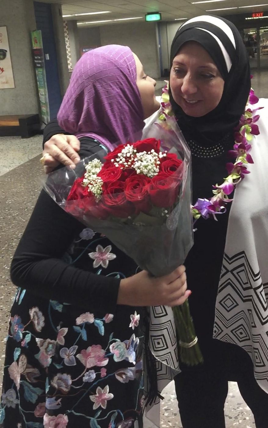 Noran Elshikh, left, greets her grandmother Wafa Yahia at Honolulu's Daniel K. Inouye International Airport after she arrived from Syria on Saturday, Aug. 12, 2017. Ismail Elshikh is a plaintiff in Hawaii's challenge to the travel ban. The lawsuit argues that the ban prevented Wafa Yahia, his Syrian mother-in-law, from visiting. (Ismail Elshikh via AP)