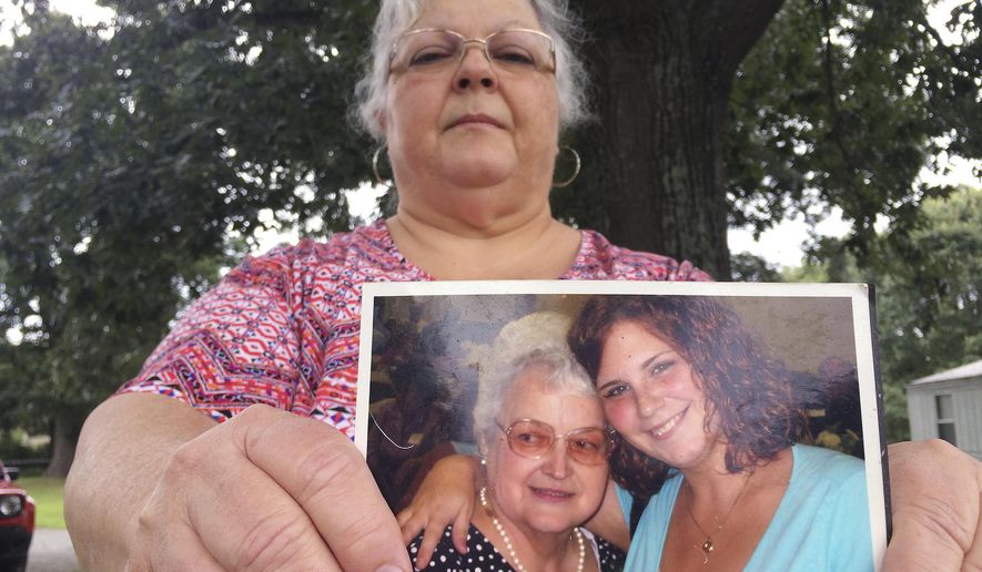 Susan Bro, the mother of Heather Heyer, holds a photo of Bro&#39;s mother and her daughter, Monday, Aug. 14, 2017, in Charlottesville, Va. Heyer was killed Saturday, Aug. 12, 2017, when police say a man plowed his car into a group of demonstrators protesting the white nationalist rally. Bro said that she is going to bare her soul to fight for the cause that her daughter died for. (AP Photo/Joshua Replogle)