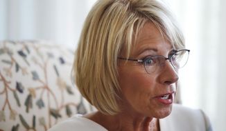 In this Aug. 9, 2017, photo, Education Secretary Betsy DeVos is interviewed by The Associated Press in her office at the Education Department in Washington. It’s been six months since her bruising Senate confirmation battle, and DeVos remains highly divisive. (AP Photo/Jacquelyn Martin)