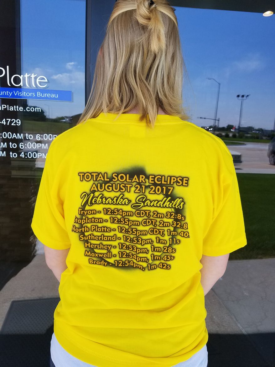 Amanda Connick of North Platte, Nebraska, sports a T-shirt advertising the best times and locations for eclipse-viewing on the Nebraska Sandhills. (Valerie Richardson/The Washington Times)