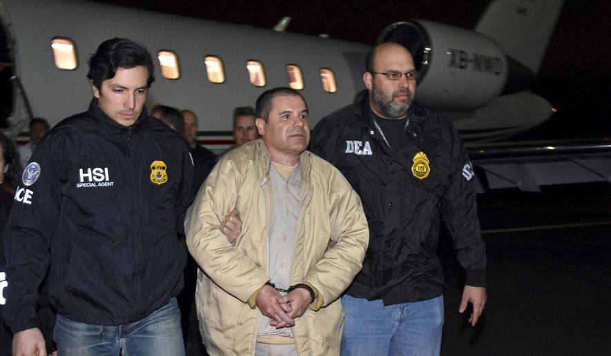 FILE - In this Jan. 19, 2017, file photo provided U.S. law enforcement, authorities escort Joaquin "El Chapo" Guzman, center, from a plane to a waiting caravan of SUVs at Long Island MacArthur Airport, in Ronkonkoma, N.Y. Guzman wants new lawyers in his U.S. drug trafficking case. Guzman is scheduled to appear in federal court in Brooklyn on Monday, Aug. 14. He's seeking to have his public defenders replaced by private lawyers, but questions remain about how they will get paid. (U.S. law enforcement via AP, File)