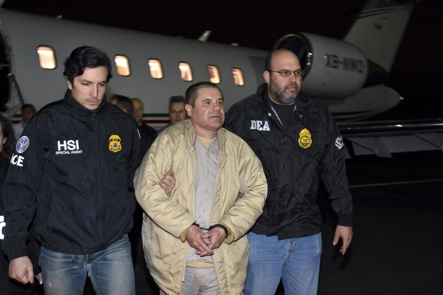 FILE - In this Jan. 19, 2017, file photo provided U.S. law enforcement, authorities escort Joaquin "El Chapo" Guzman, center, from a plane to a waiting caravan of SUVs at Long Island MacArthur Airport, in Ronkonkoma, N.Y. Guzman wants new lawyers in his U.S. drug trafficking case. Guzman is scheduled to appear in federal court in Brooklyn on Monday, Aug. 14. He's seeking to have his public defenders replaced by private lawyers, but questions remain about how they will get paid. (U.S. law enforcement via AP, File)