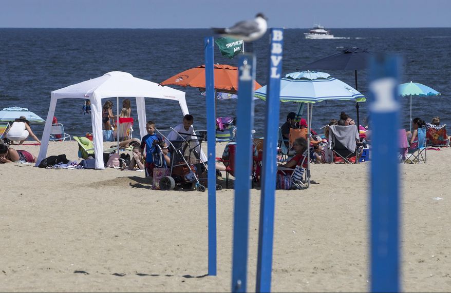 Tents and canopies set up on the beach in Belmar, N.J., Wednesday, Aug. 9, 2017. Locals say that they welcome the Belmar Borough Council's recent proposal to ban the use of such tents and canopies — a practice known as "beach spreading." (Doug Hood /The Asbury Park Press via AP)
