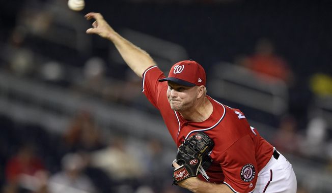 Washington Nationals relief pitcher Ryan Madson delivers a pitch during the eighth inning of the team&#x27;s baseball game against the San Francisco Giants, early Sunday, Aug. 13, 2017, in Washington. The Nationals won 3-1. (AP Photo/Nick Wass)