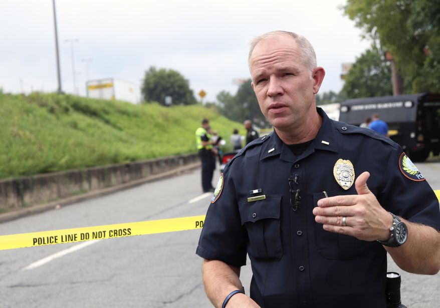 Little Rock Police Lt. Steve McClanahan speaks Monday, Aug. 14, 2017, near an interstate highway in Little Rock, Ark., about the city's increasing number of homicides. The city on Monday matched its homicide total from 2016 and is on a pace to approach the pace from 1993, when gang warfare led to a spike in the city's murder rate. (AP Photo/Kelly P. Kissel)