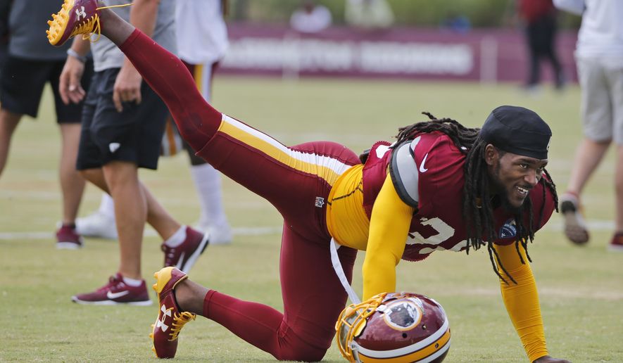 FILE - This Aug. 1, 2017 file photo shows Washington Redskins free safety D.J. Swearinger (36) stretching during practice at the Washington Redskins NFL training camp in Richmond, Va. The Redskins are hoping Swearinger is the answer at their free safety position. The team signed the 25 year old in the offseason and also gained a very vocal leader. Swearinger celebrates each defensive stand the defense makes, even in practice, and says he views it as his job to keep energy levels high. (AP Photo/Steve Helber, file)