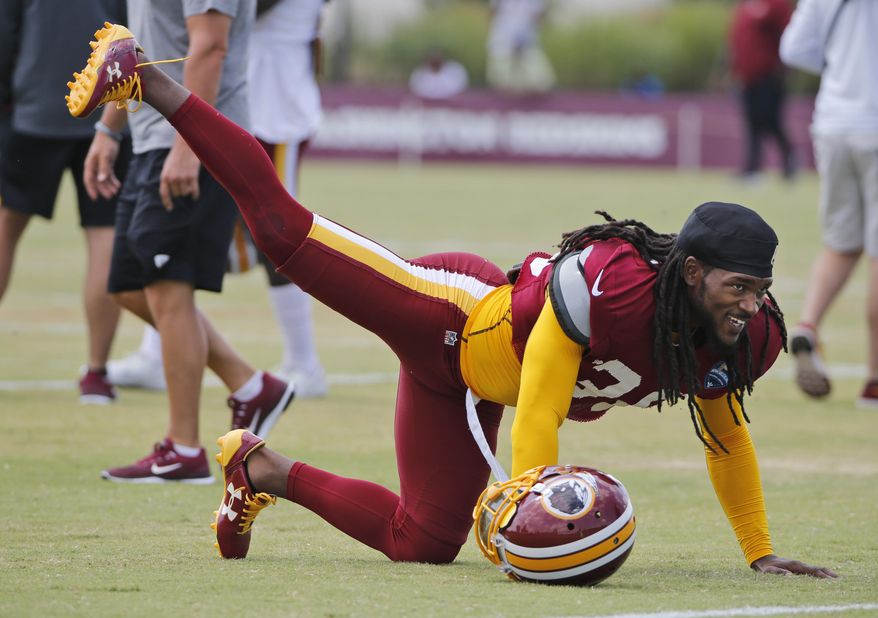 FILE - This Aug. 1, 2017 file photo shows Washington Redskins free safety D.J. Swearinger (36) stretching during practice at the Washington Redskins NFL training camp in Richmond, Va. The Redskins are hoping Swearinger is the answer at their free safety position. The team signed the 25 year old in the offseason and also gained a very vocal leader. Swearinger celebrates each defensive stand the defense makes, even in practice, and says he views it as his job to keep energy levels high. (AP Photo/Steve Helber, file)