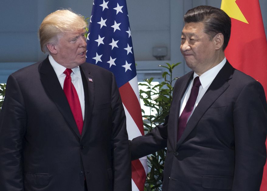 In this July 8, 2017, file photo, U.S. President Donald Trump, left, and China&#39;s President Xi Jinping arrive for a meeting on the sidelines of the G-20 Summit in Hamburg, Germany. Trump is planning to sign an executive action asking the U.S. Trade Representative to consider investigating China for the theft of U.S. technology and intellectual property. He is taking the step even as he seeks China’s help with the ongoing crisis with North Korea. (Saul Loeb/Pool Photo via AP, File)