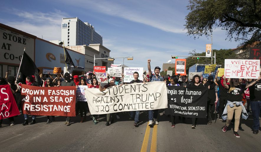 FILE - In this Friday, Jan. 20, 2017. file photo, anti-Donald Trump protesters block traffic as they march in the middle of Guadalupe Street next to the University of Texas at Austin on Inauguration Day. In 2017, Republican legislators in at least six states, including Texas, have introduced bills that would shield drivers from civil liability if they unintentionally injure or kill protesters obstructing traffic. (Jay Janner/Austin American-Statesman via AP)