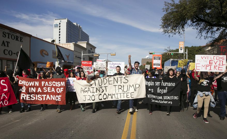 FILE - In this Friday, Jan. 20, 2017. file photo, anti-Donald Trump protesters block traffic as they march in the middle of Guadalupe Street next to the University of Texas at Austin on Inauguration Day. In 2017, Republican legislators in at least six states, including Texas, have introduced bills that would shield drivers from civil liability if they unintentionally injure or kill protesters obstructing traffic. (Jay Janner/Austin American-Statesman via AP)